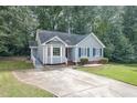 Inviting home featuring a well-manicured lawn, driveway, and beautiful light-blue exterior at 5008 Dantonville Ct, Knightdale, NC 27545