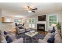 Inviting living room featuring a fireplace, ceiling fan and ample natural light from windows and french doors at 5008 Dantonville Ct, Knightdale, NC 27545