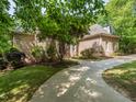 Brick house featuring a long driveway, lush greenery, and well-maintained landscaping at 540 Vista Del Lago Ln, Wake Forest, NC 27587