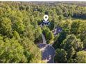 Wonderful aerial view highlighting the property's private driveway nestled amongst mature trees at 66 Sweet Meadow Ln, Pittsboro, NC 27312