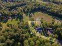 Stunning aerial view showcasing the property's location near a golf course and lush surrounding trees at 66 Sweet Meadow Ln, Pittsboro, NC 27312