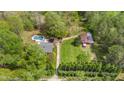 Aerial view of a sprawling property with a pool, barn, and well-maintained grounds, showcasing its vast potential at 6971 Shady Creek Trl, Rougemont, NC 27572
