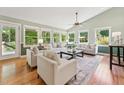 Bright living room with large windows, hardwood floors, and comfortable seating, creating an inviting space at 6971 Shady Creek Trl, Rougemont, NC 27572