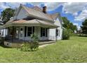 Exterior view of house with covered porch, black railing, and green lawn at 705 Washington St, Graham, NC 27253