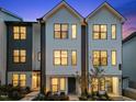 Charming modern townhome featuring a well-manicured lawn and inviting front facade at 710 W North St # 101, Raleigh, NC 27603