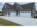 Spacious three-car garage offering ample parking and storage space, enhancing the home's functionality at 80 Water Willow Ln, Zebulon, NC 27597