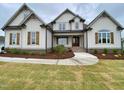 Beautiful home with charming wood shutters and manicured lawn at 90 Water Willow Ln, Zebulon, NC 27597