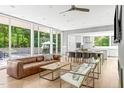 Bright open-concept living space with floor-to-ceiling windows and hardwood floors at 9021 Albatross Ct, Raleigh, NC 27613