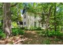 Quaint home nestled amongst lush trees and foliage, offering a tranquil setting at 903 Nicholas St, Henderson, NC 27536