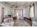 Living room with floral accents, a decorative fireplace, and large window at 903 Nicholas St, Henderson, NC 27536