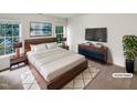 Beautiful bedroom with a large bed, white bedding, two windows, and dark furniture at 105 Crosswaite Way, Cary, NC 27518