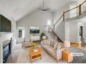 Bright, open living room with fireplace, vaulted ceilings, and view of the staircase at 105 Crosswaite Way, Cary, NC 27518