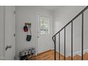 A view of the entrance door, wood floors, coat rack, and a shoe rack in the entryway at 105 Fidelity St # B19, Carrboro, NC 27510