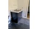 The interior features a utility sink with a black cabinet and countertop next to black floor at 1403 S Roxboro Street, Durham, NC 27703