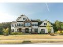 Beautiful two-story home featuring a manicured lawn, stone accents, dark shutters, and ample curb appeal at 1475 Sierra Glen Cir, Apex, NC 27502