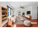 Bright living room boasts stylish decor, comfortable seating, and a ceiling fan for added comfort at 148 Daneborg Rd, Durham, NC 27703