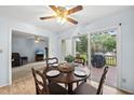 Cozy dining area featuring a wooden table and chairs, with sliding glass doors leading to an outdoor deck at 1609 Forest Rd, Wake Forest, NC 27587