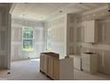 A spacious kitchen with drywall and some cabinets in the process of being installed at 163 Batten Hill Ln, Selma, NC 27576