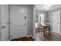 Welcoming entryway with hardwood floors, gray walls, and a dining area with natural light at 166 Greenmont Ln, Cary, NC 27511