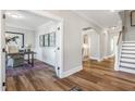 Inviting foyer with hardwood floors leading to an office and staircase in neutral color palette at 212 Augusta Pond Way # 128, Raleigh, NC 27603