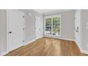 Bright bedroom with hardwood floors and large window offering a scenic outdoor view at 2204 Bellaire Ave, Raleigh, NC 27608