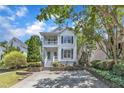 Charming two-story home featuring a double porch, black shutters, and long driveway at 2204 Bellaire Ave, Raleigh, NC 27608