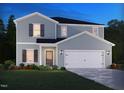 Charming two-story home with blue siding, shutters, green lawn and manicured landscaping at 2250 Cherry Creek Rd, Haw River, NC 27258