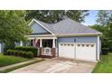 Beautiful home showcasing architectural details, manicured landscaping, and an attached two-car garage at 2313 Filigree Ct, Raleigh, NC 27614