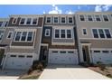 Attractive townhome exteriors display neutral tones and individual attached garages at 2733 Hunter Woods Dr # 570, Apex, NC 27502