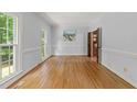 Light-filled room with beautiful hardwood floors, neutral walls, and classic molding at 2840 Mattlyn Ct, Raleigh, NC 27613