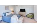 Serene bedroom with a cozy chair, soft bedding, and a mounted television at 2929 Great Lawn Rd, Apex, NC 27502