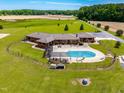 Aerial view of a single-Gathering home featuring an in-ground pool, large yard and beautiful landscaping at 3187 Wilsons Mills Rd, Smithfield, NC 27577