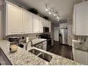 Modern kitchen features granite countertops, stainless steel appliances, and subway tile backsplash at 364 Bayleigh Ct, Garner, NC 27529