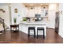 Bright kitchen features white cabinets, stainless steel appliances, and a quartz breakfast bar at 4355 Pond Pine Trl, Morrisville, NC 27560