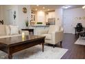 Open-concept living area with modern furnishings and wood flooring at 4355 Pond Pine Trl, Morrisville, NC 27560
