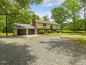 Traditional two-story home with an attached two-car garage and a well-maintained lawn with mature trees at 4508 Old Us 421 N N, Siler City, NC 27344