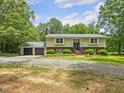 Traditional two-story home with an attached two-car garage and a well-maintained lawn with mature trees at 4508 Old Us 421 N N, Siler City, NC 27344