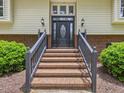 Elegant front entrance with brick steps and a decorative door with sidelights and sconces at 4508 Old Us 421 N N, Siler City, NC 27344
