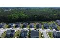 An aerial shot of houses on a street surrounded by trees, featuring driveways and crosswalk at 4907 Sleepy Falls, Knightdale, NC 27545