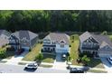 Scenic aerial view of the neighborhood, highlighting the two-story home, mature trees, and community layout at 4907 Sleepy Falls Run, Knightdale, NC 27545