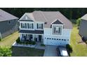 Stunning aerial view of the two-story home, showcasing its roofline, driveway, landscaping, and surrounding neighborhood at 4907 Sleepy Falls Run, Knightdale, NC 27545