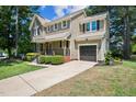 Traditional home with attached garage, manicured landscaping and a cozy covered porch at 5505 Pennfine Dr, Raleigh, NC 27610