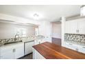 Bright kitchen featuring white cabinets, granite countertops, and a convenient center island at 5505 Pennfine Dr, Raleigh, NC 27610