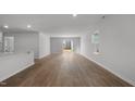 Spacious living room with sliding glass doors and modern wood-look flooring at 556 Stream Walk Xing, Wendell, NC 27591