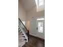 Bright foyer with hardwood floors, a staircase, and a front door with glass panels at 5638 Wade Park Blvd, Raleigh, NC 27607
