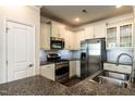 Bright kitchen boasts stainless appliances, granite countertops, and white cabinetry at 5638 Wade Park Blvd, Raleigh, NC 27607