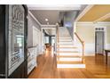 Bright foyer with hardwood floors, staircase, and decorative glass door features at 80 Shambley Meadows Dr, Pittsboro, NC 27312