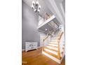 Staircase with decorative painted chest and soaring ceiling, creating an open and airy feel at 80 Shambley Meadows Dr, Pittsboro, NC 27312