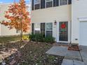Close-up of home's entrance, accented with a decorative wreath and well-kept garden beds at 821 Stackhurst Way, Wake Forest, NC 27587