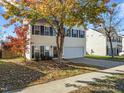 Lovely home with attached garage and neat landscaping, enhanced by the shade of mature trees at 821 Stackhurst Way, Wake Forest, NC 27587